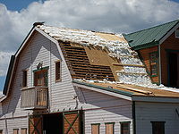 Tornado damage to a well-constructed barn roof